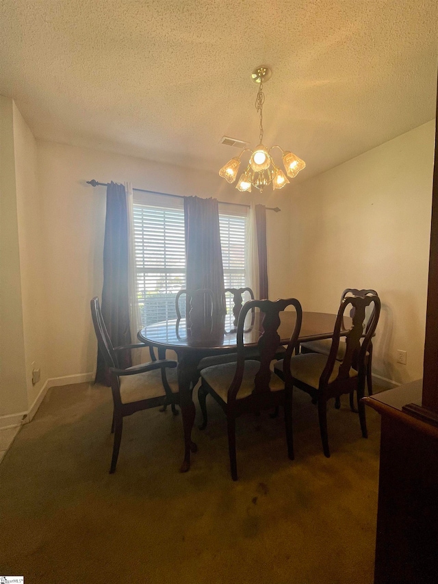 carpeted dining area featuring an inviting chandelier and a textured ceiling