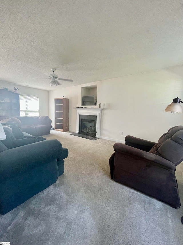 living room with carpet, a textured ceiling, and ceiling fan