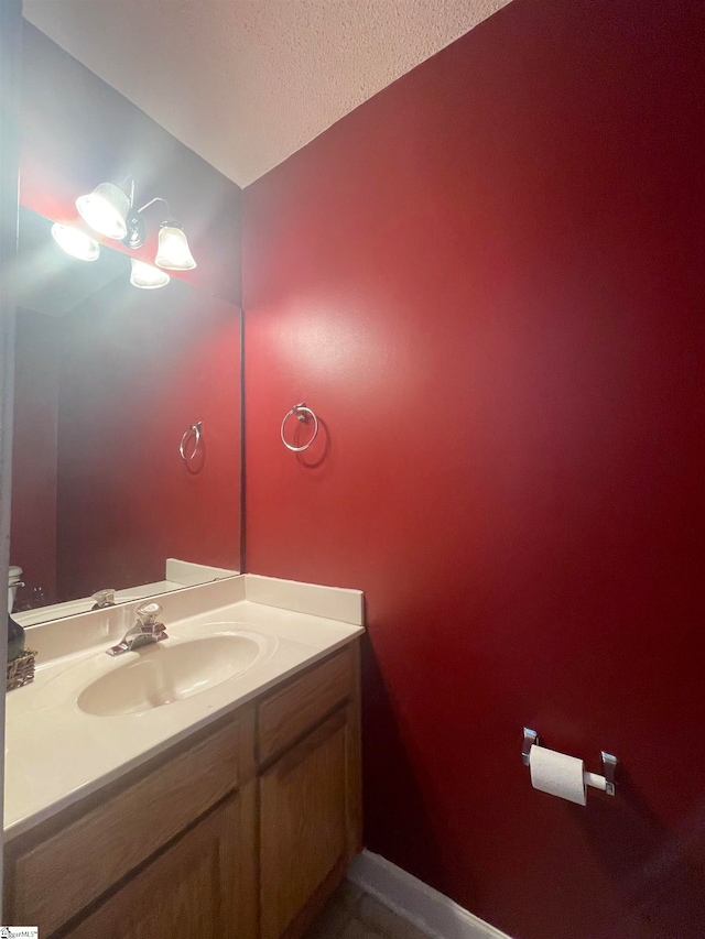 bathroom with vanity and a textured ceiling