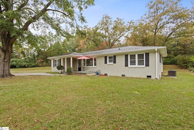 back of property with a yard and central air condition unit