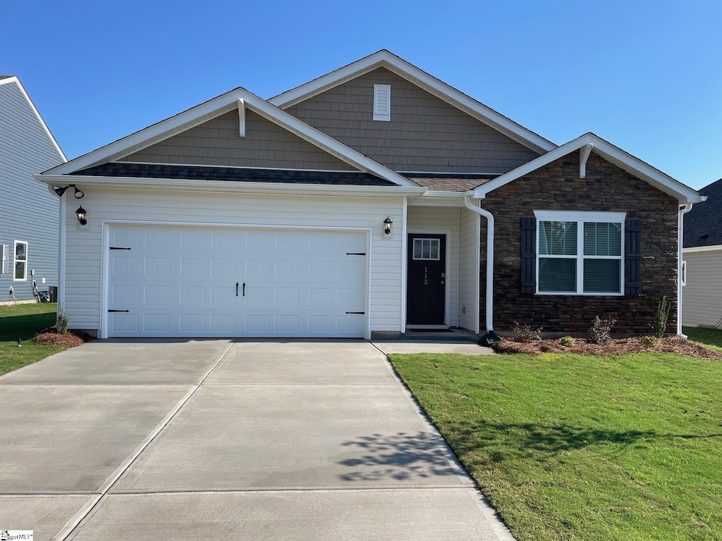 view of front of house with a front yard and a garage