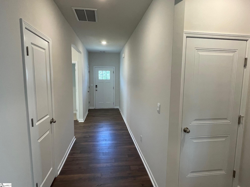 hall with dark wood-type flooring