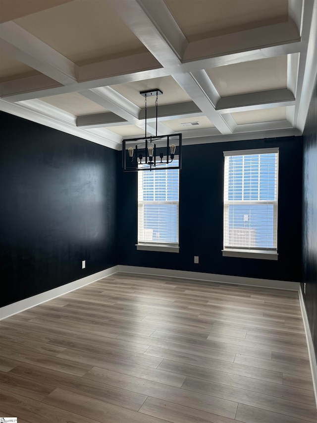 unfurnished dining area featuring light hardwood / wood-style floors, a healthy amount of sunlight, and an inviting chandelier