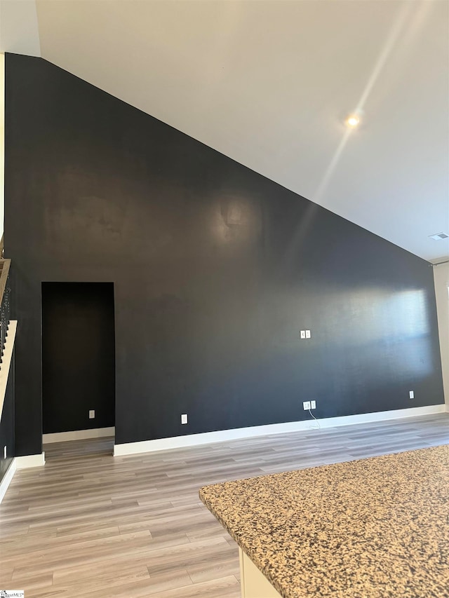 interior space with lofted ceiling and light wood-type flooring