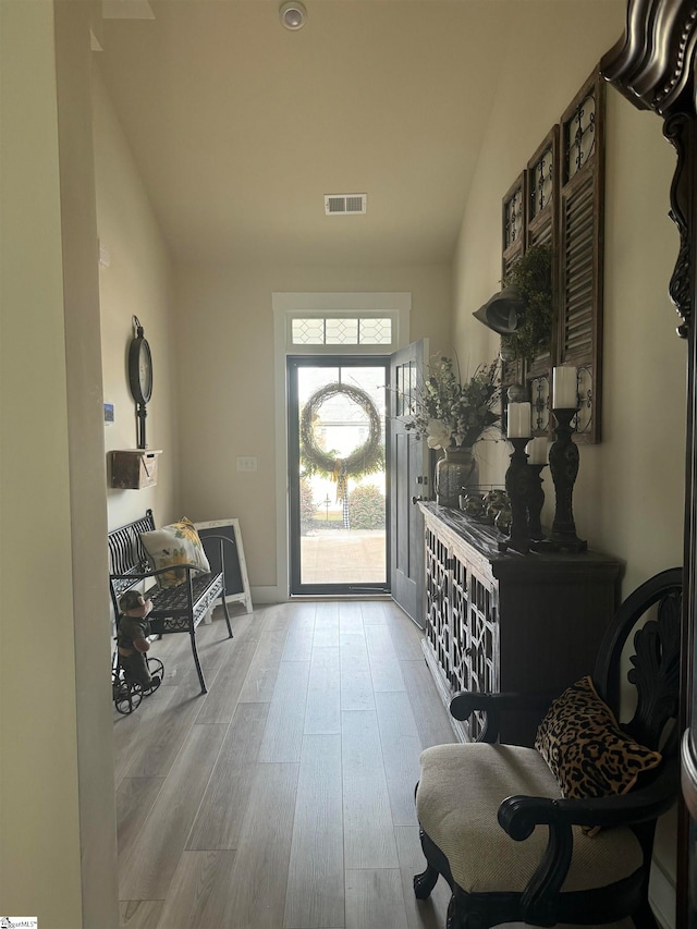 entrance foyer with light hardwood / wood-style flooring and vaulted ceiling