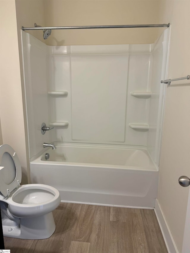 bathroom with shower / tub combination, wood-type flooring, and toilet