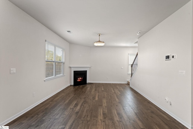 unfurnished living room featuring dark wood-type flooring