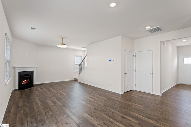 unfurnished living room featuring dark hardwood / wood-style floors