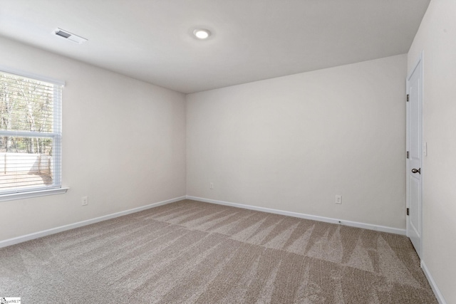 unfurnished room featuring carpet floors and a wealth of natural light