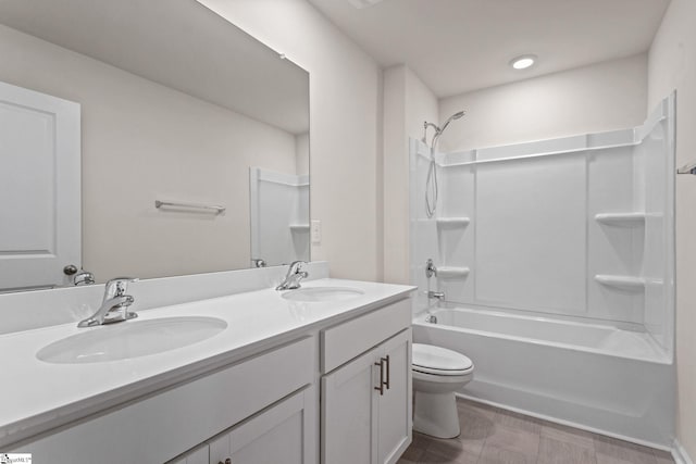 full bathroom featuring  shower combination, vanity, and toilet