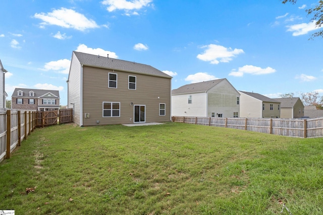 back of property featuring a yard and a patio area