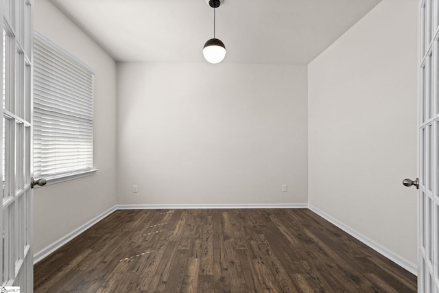 spare room with dark wood-type flooring