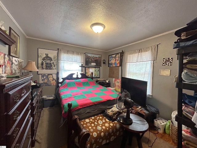 bedroom featuring crown molding and a textured ceiling