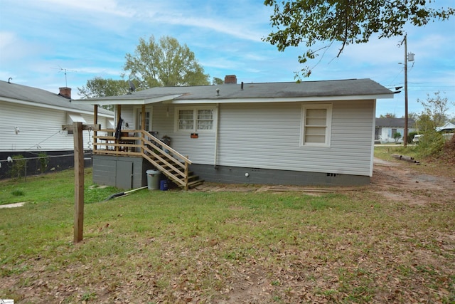 rear view of house with a yard