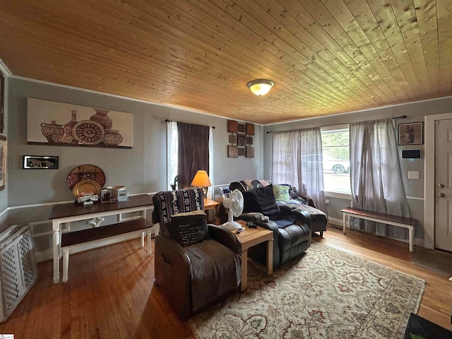 living room with wood ceiling, wood-type flooring, and crown molding