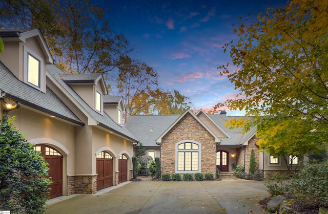 property exterior at dusk with a garage