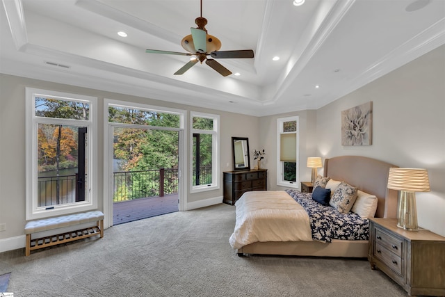 bedroom featuring ceiling fan, access to outside, a tray ceiling, ornamental molding, and light colored carpet