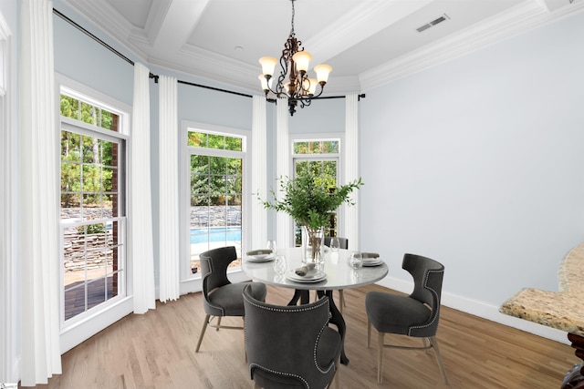 dining room with crown molding, a chandelier, and light wood-type flooring