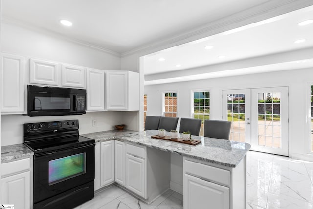 kitchen with kitchen peninsula, white cabinets, and black appliances