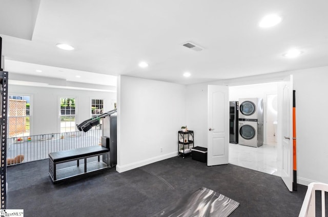 exercise room with stacked washer and dryer