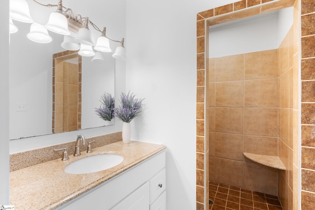 bathroom featuring vanity and a tile shower