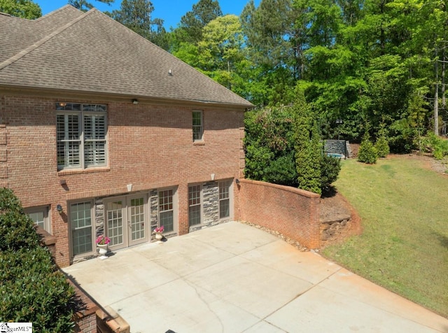 back of house featuring a patio and a yard