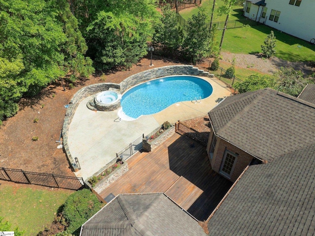 view of swimming pool featuring a wooden deck, a patio area, an in ground hot tub, and a lawn