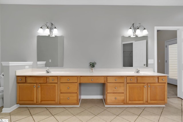 bathroom featuring vanity, toilet, tile patterned floors, and an inviting chandelier