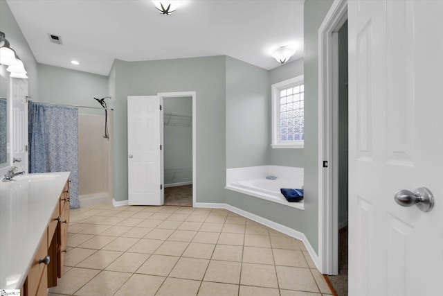 bathroom featuring vanity, independent shower and bath, and tile patterned flooring