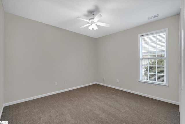 carpeted empty room featuring ceiling fan