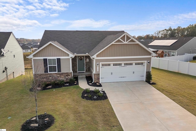 craftsman inspired home with a front lawn and a garage