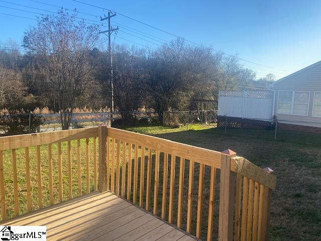 wooden deck featuring a yard