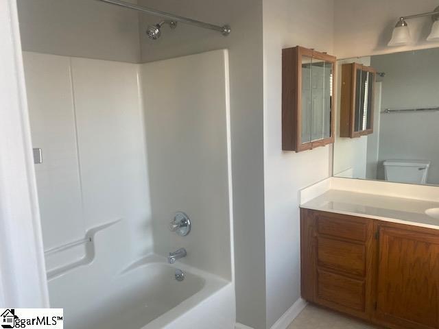 full bathroom featuring toilet, shower / washtub combination, and vanity