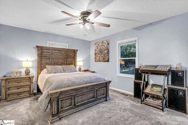 bedroom with ceiling fan, a textured ceiling, and light colored carpet