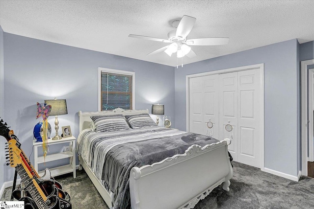 bedroom featuring a closet, a textured ceiling, dark carpet, and ceiling fan