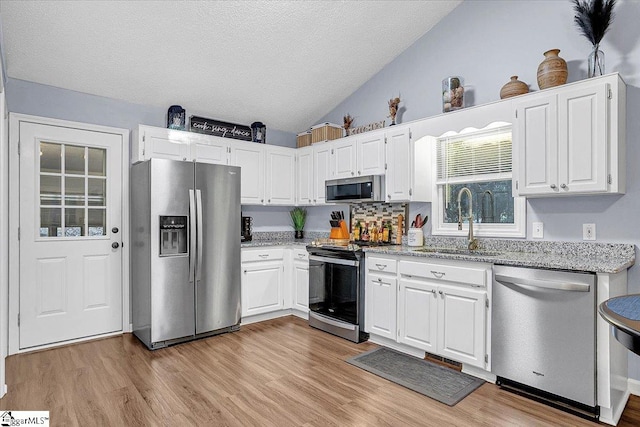 kitchen featuring sink, appliances with stainless steel finishes, and white cabinetry