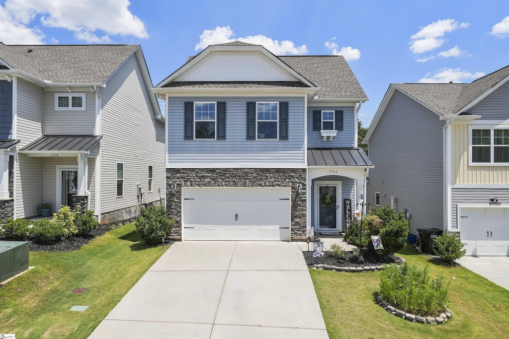 view of front of property with a front yard and a garage