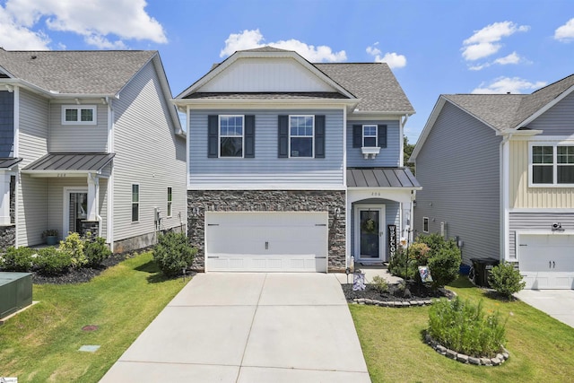 view of front of property with a front yard and a garage