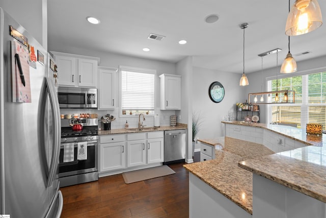 kitchen with sink, appliances with stainless steel finishes, and white cabinets