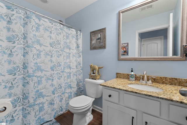 bathroom with vanity, toilet, a shower with curtain, and hardwood / wood-style floors