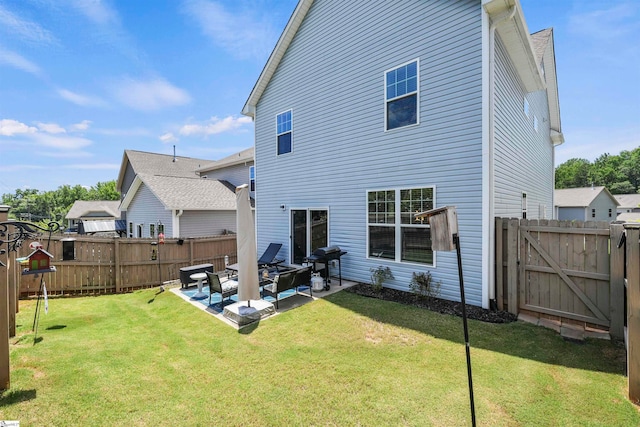 rear view of house featuring a patio area and a lawn