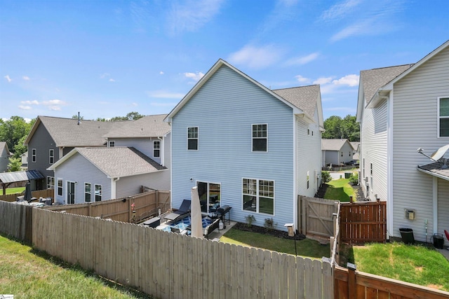 rear view of house with a patio and a lawn