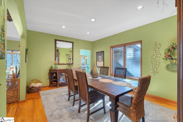 dining room with a wealth of natural light and light hardwood / wood-style flooring