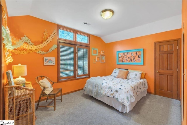 bedroom with vaulted ceiling and carpet floors