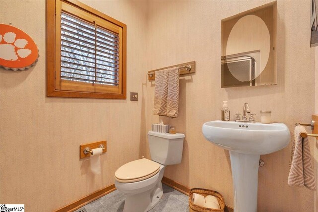 bathroom with toilet and tile patterned floors