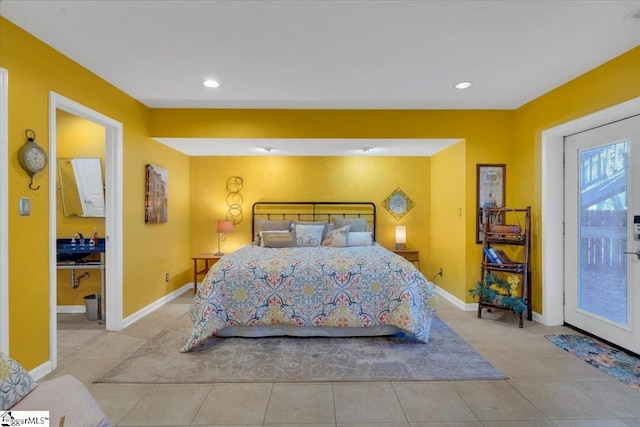 bedroom featuring access to outside, light tile patterned flooring, and sink