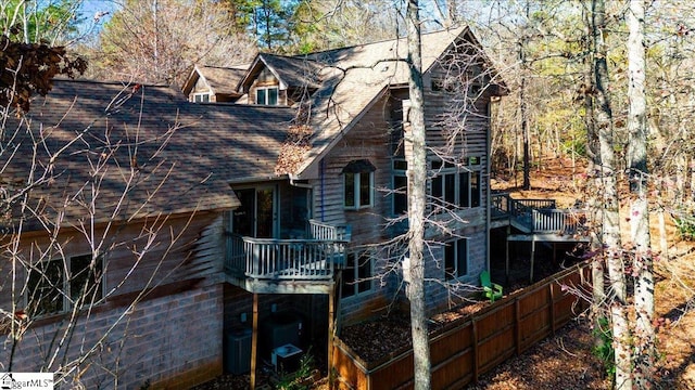 rear view of house with a wooden deck