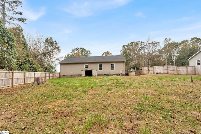 back of property featuring a lawn