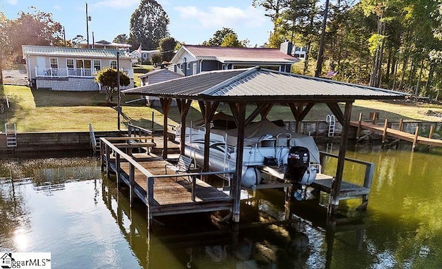 dock area featuring a water view and a lawn