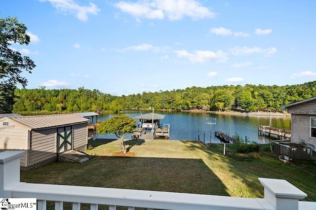 view of dock with a lawn and a water view